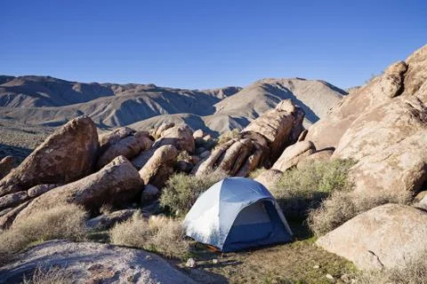 Tent Set Up In The Desert Between Rocks Stock Photos