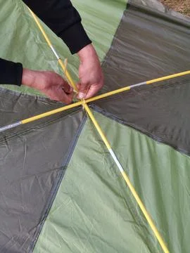 Tent set up process by hand made background Stock Photos