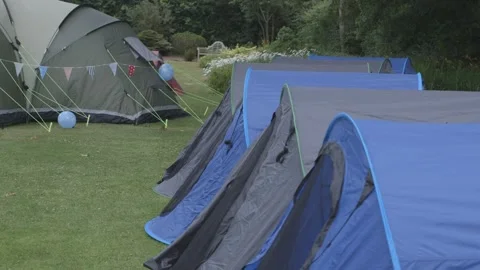 Tent set up in a row in field Stock Footage 247331227
