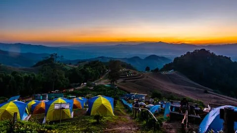 Tent in the sunset overlooking mountains Stock Photos