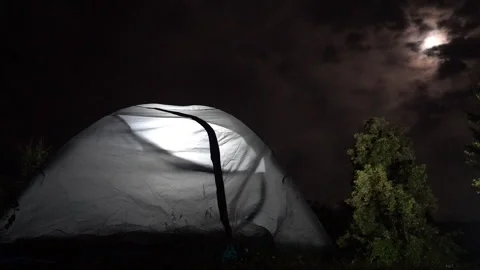 Tent Under the Moonlight as Clouds Drift – Timelapse 動画素材 311669614