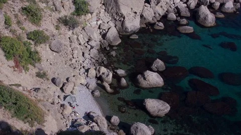 Tent on a wild beach surrounded by rocks Stock Footage 81064729