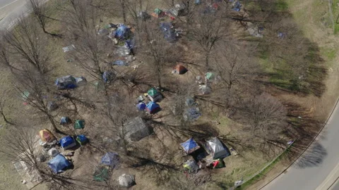 Tents Next to Interstate in Big City Homeless Encampment - Aerial Stock Footage 148976537