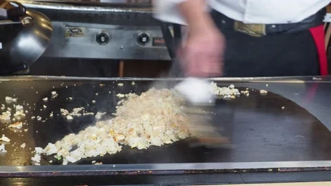 Teppanyaki Chef, Cooking And Serving Egg Fried Rice At A Restaurant, London, UK Stock Footage 154353673
