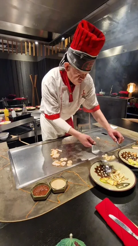 Teppanyaki Chef, Cooking and Serving Delicious Food At A Restaurant, London, UK Stock-Footage 239372671