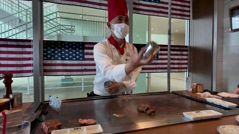 Teppanyaki chef performing cooking show at steak restaurant in Japan Stock Footage 325686146