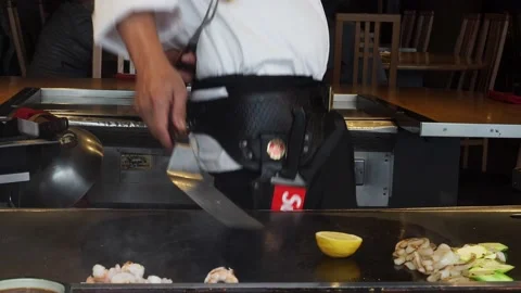 Teppanyaki Chef, Preforming Tricks With A Lemon, At A Restaurant, London, UK Stock Footage 154348893