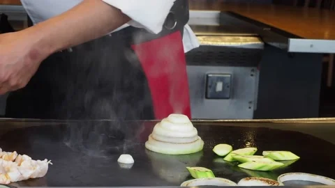 Teppanyaki Chef, Preforming Tricks Onion Rings At A Restaurant, London, UK Stock Footage 154349944