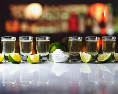 Tequila , lime and salt on table in bar Stock Photos
