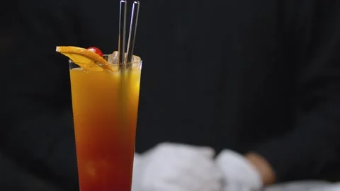 Tequila Sunrise Cocktail rotating on the table Stock Footage 131363086