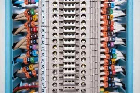 Terminal block with connected and numbered wires leaving the cable channel. Stock Photos
