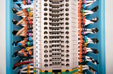Terminal block with connected and numbered wires leaving the cable channel. Stock Photos
