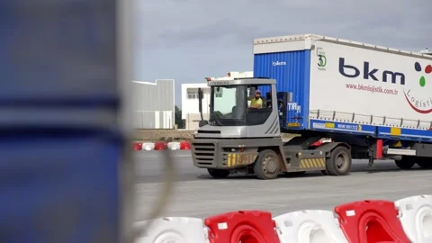 Terminal Tractor Towing Freight Trailer Across Logistics Yard Stock Footage 338371991