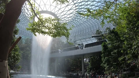 Terminal train passing Garden and waterfall in Jewel Changi Airport Stock-Footage 110797426