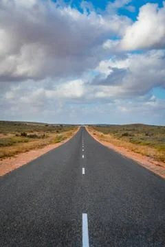 Termite mounts along the empty road in Western Australia close to Exmouth dur Stock Photos