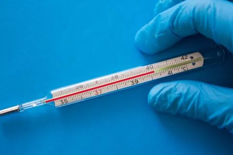 Termometer in a hand of a doctor Stock Photos