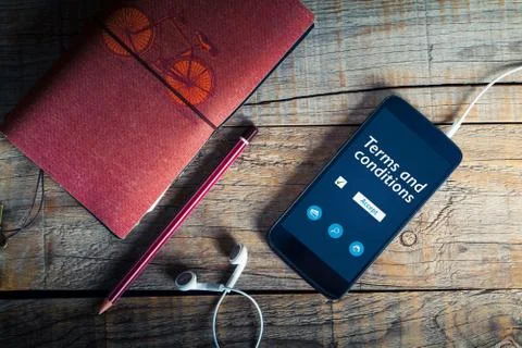 Terms and conditions document in a mobile phone screen. Stock Photos