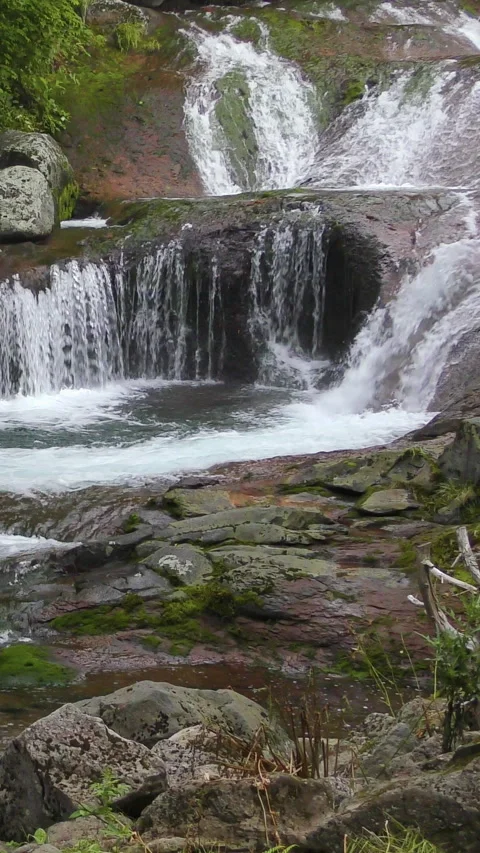 Terraced Cascade Over Reddish Mossy Rock Vertical Video 库存影片 346191677