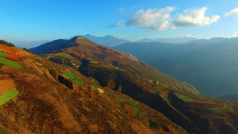 Terraced fields create colorful patterns on the mountains of yunnan china Video stock 311820226