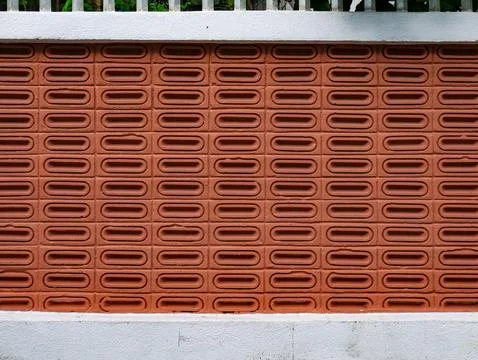 Terracotta Perforated Brick Wall Pattern with White Concrete Border Stock Photos