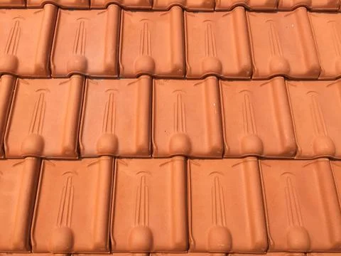 Terracotta roof tiles as roofing material for building Stock Photos