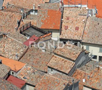Terracotta tiled roofs nearby in crowded village in Central Italy Stock Photos