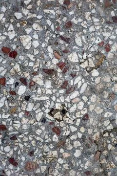 Terrazzo flooring surface with a light gray base and embedded multicolor stone Stock Photos