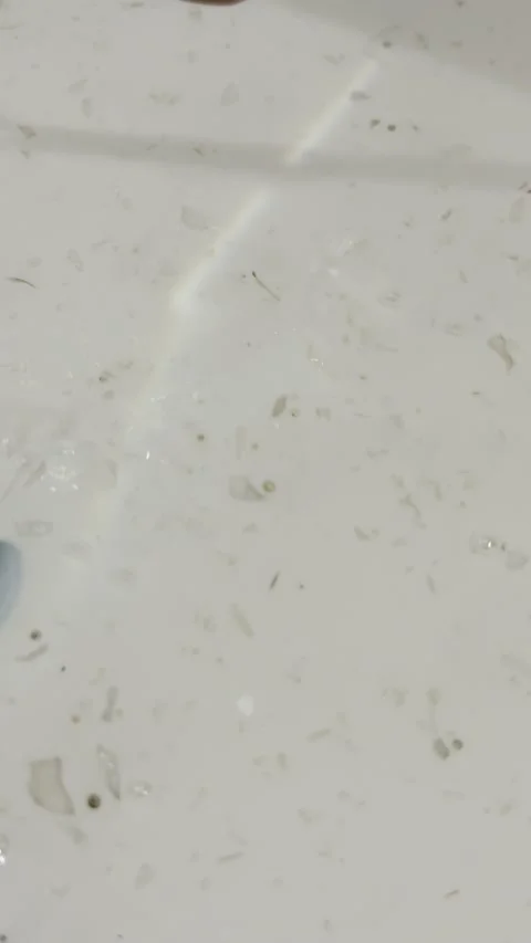Terrazzo Sink Water Flow with Bubbles and Subtle Rainbow Reflection Stock Footage 330675135