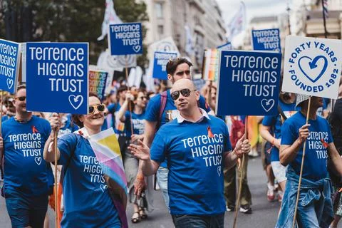 Terrence Higgins Trust with flags and banners celebrating London LGBTQ Pride  Foto stock