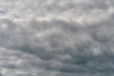 A terrible black cloud hangs in the sky before the rain. Bad weather. Hurrica Stock Photos