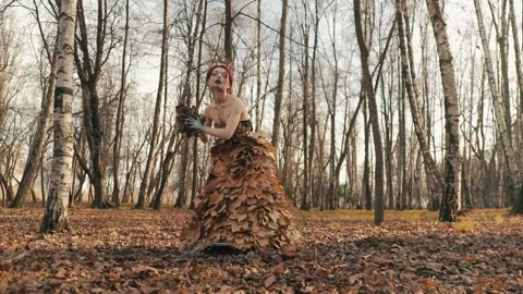 A terrible embittered witch in an autumn forest with  Stock Footage 169214266