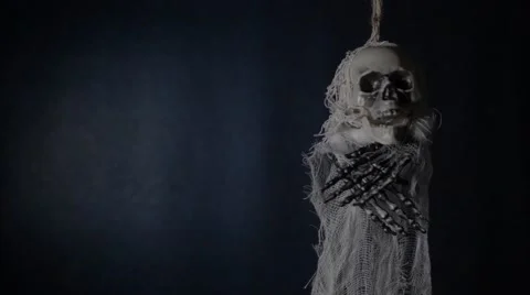 Terrible skeleton hanged on a dark blue background. Stock Footage 68723725