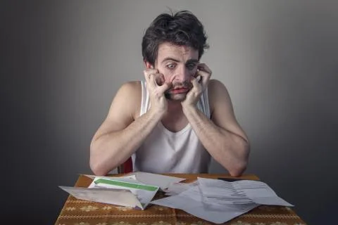 Terrified with bills Stock Photos