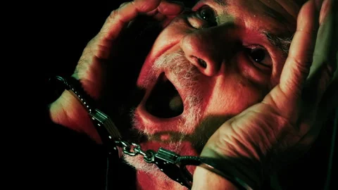 Terrified Man in Handcuffs Panic Face in Darkness 1 Stock Footage 324612121