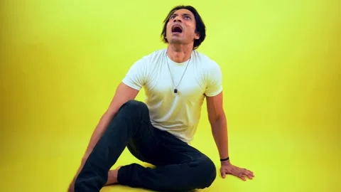 Terrified man sitting on floor Stock Footage 278023540