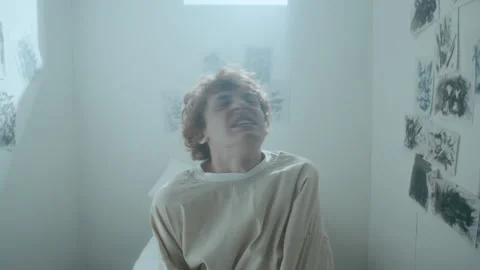 Terrified Patient in Straitjacket Screaming in Asylum Room Stock Footage 313251062