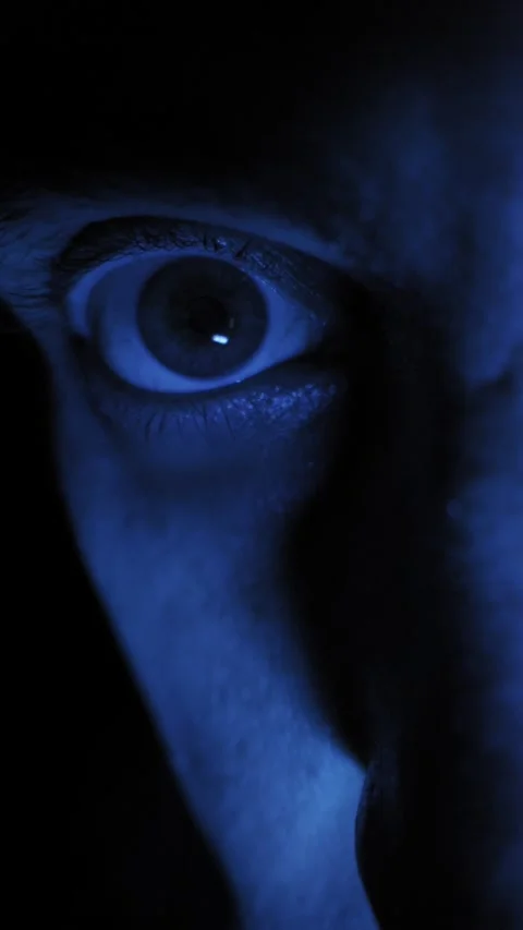 Terrified Persons Eye Staring Wide in a Dark Blue Room Vídeos de archivo 329913978