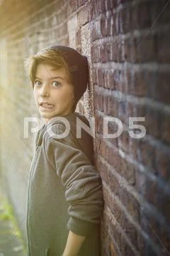 Terrified teenager boy leaning on a wall Stock Photos
