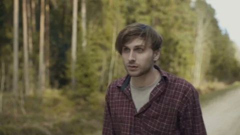 Terrified young man spits out cigarette from shock Stock Footage 81361799