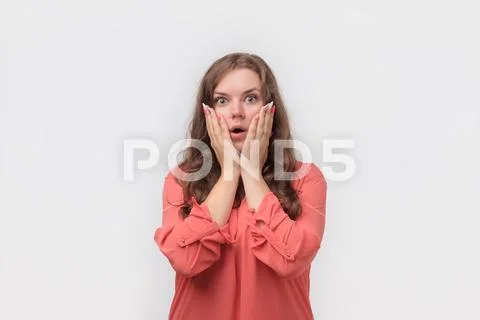 Terrified young plump woman is confused, feeling danger, she is surprised with Stock Photos