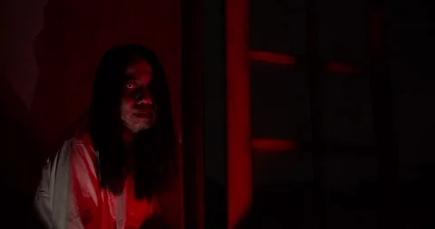 Terrifying ghost with a bloody face lurks in a dark Stock Footage 344373778