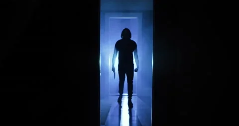 A Terrifying Killer Walks Toward Camera Holding a Knife Video stock 161600036