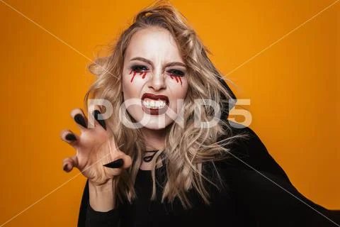Terrifying woman wearing black costume and halloween makeup looking at the ca Stock Photos