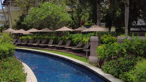 The territory of an expensive five-star hotel, a swimming pool and sun loungers Stock Footage 217499605