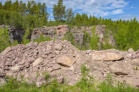 The territory of an old quarry for the extraction of raspberry quartzite Stock Photos
