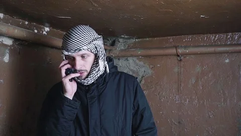 Terrorist Arab talking on the phone Video stock 82539452