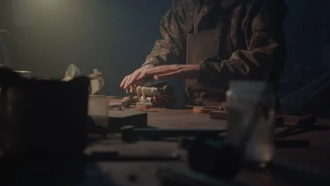A terrorist attaching a smartphone to an explosive at home Stock Footage 256020112
