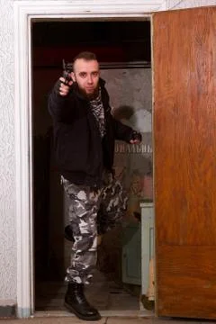 Terrorist with a gun in the stroma Stock Photos