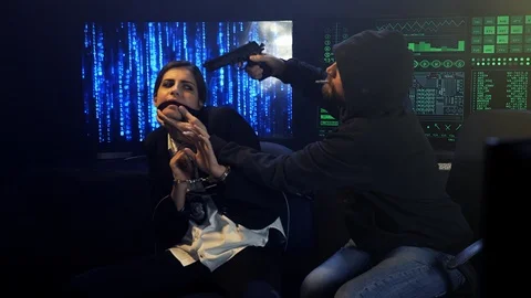 Terrorist hacker threatening with gun on head female fbi agent held hostage Stock Footage 87053609