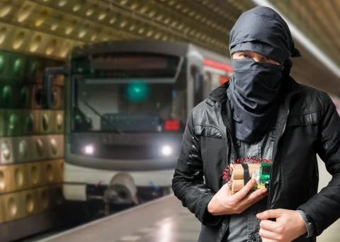 Terrorist has dynamite bomb in jacket. Train approaching underground station. Stock Photos